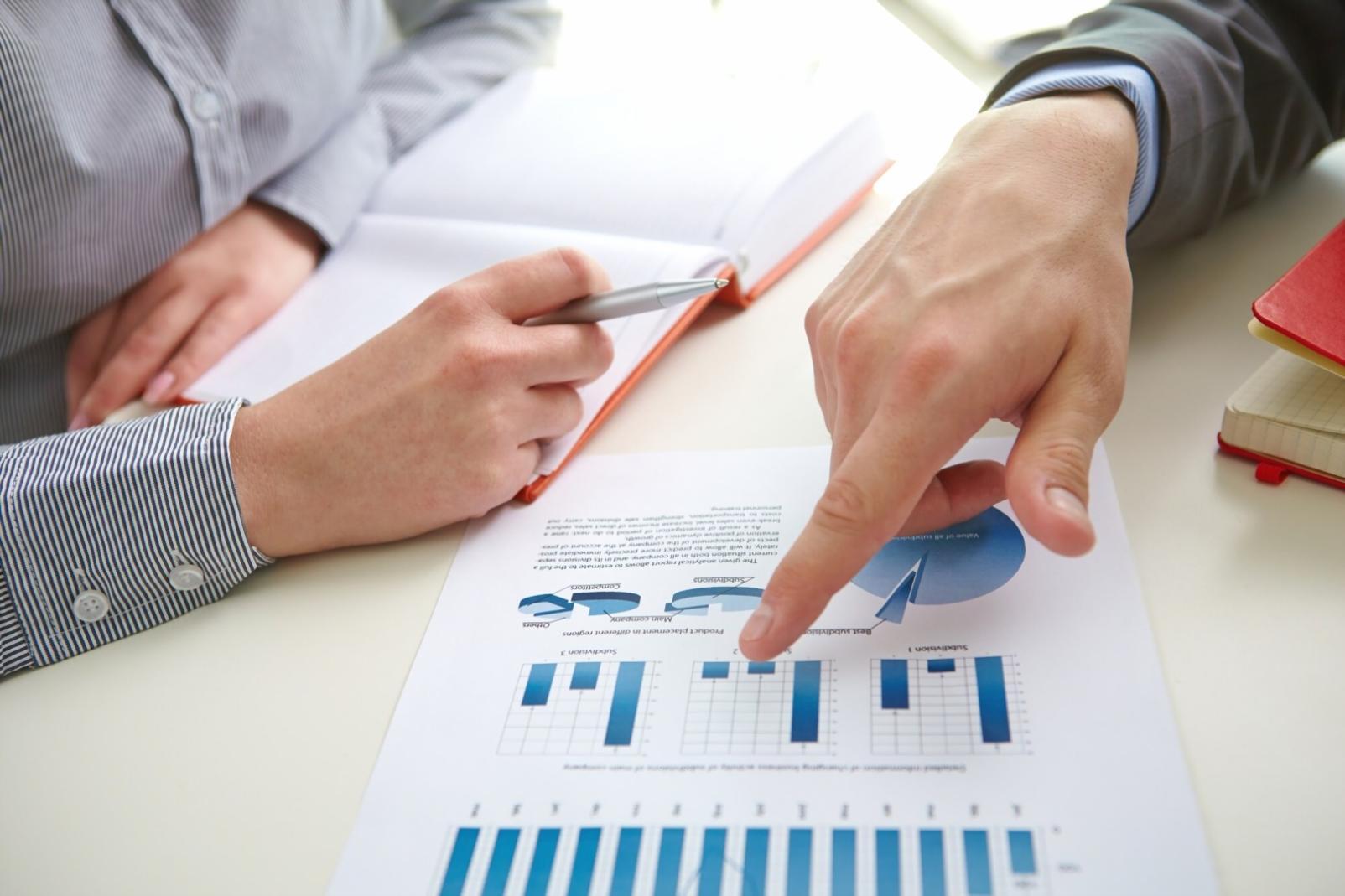 Business owner reviewing financial charts and planning documents